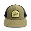 Front view of the olive Guided by Tides Trucker Hat with dark mesh and a Southern Style Fly Co. skiff and mangrove patch.