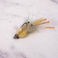 Tan Bandit Crab saltwater fly with natural shrimp and crab colors, rubber legs, weighted eyes, and weed guard