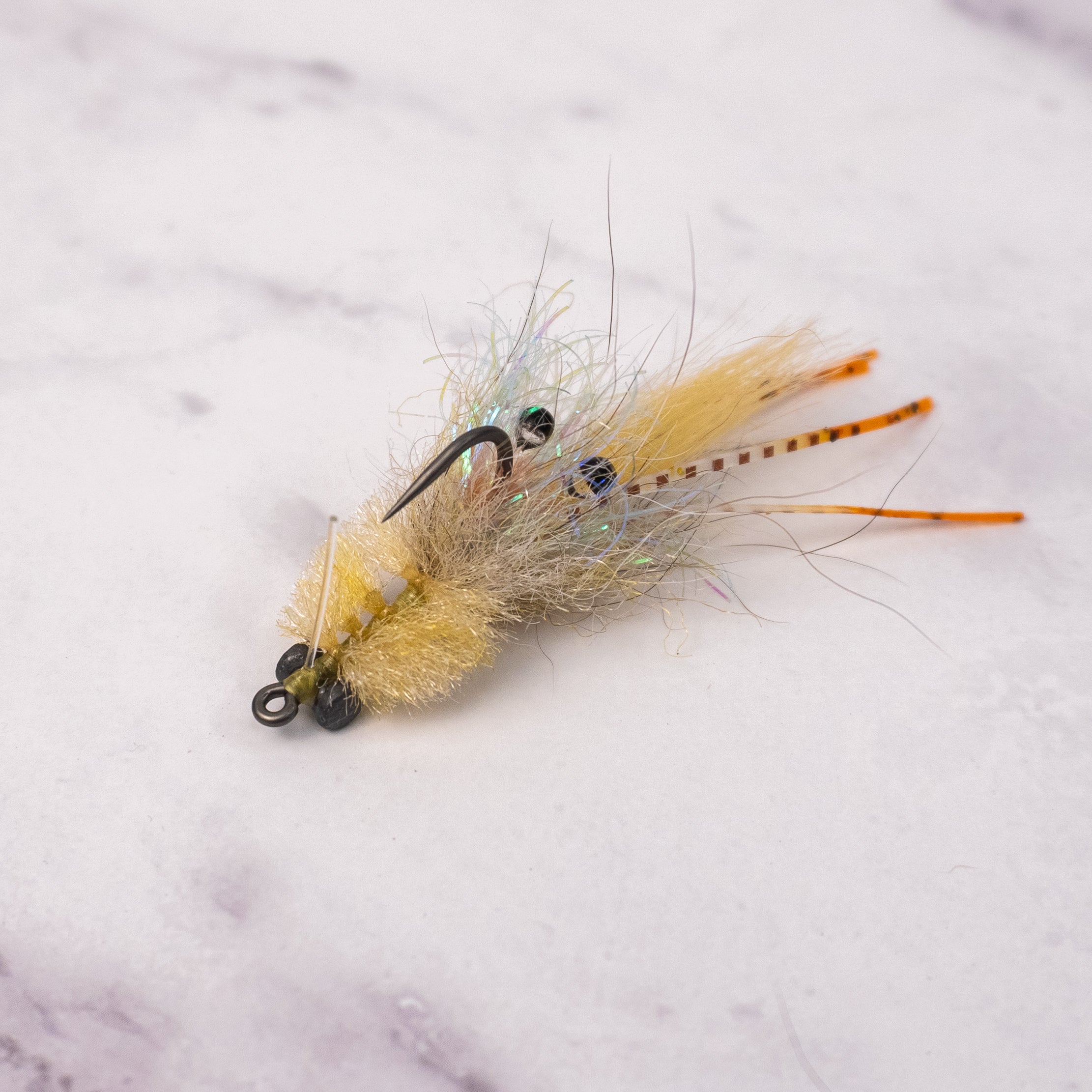 Tan Bandit Crab saltwater fly with natural shrimp and crab colors, rubber legs, weighted eyes, and weed guard