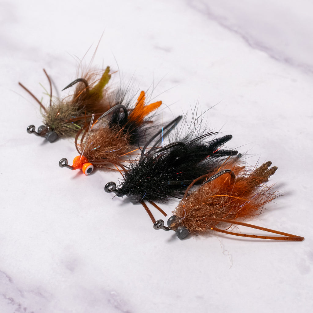 Bourbon Crab fly in brown/rust and black color variations shown together, small minimal crab pattern for redfish and black drum