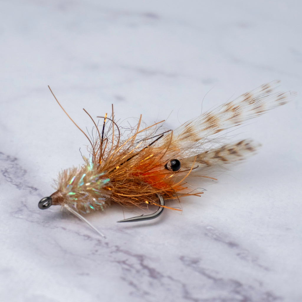 Tan and orange Bull Shrimp saltwater fly from the limited Summer Collection with barred legs, weedguard, and Size 2 Mustad Tarpon Streamer hook for shallow water redfish and snook.