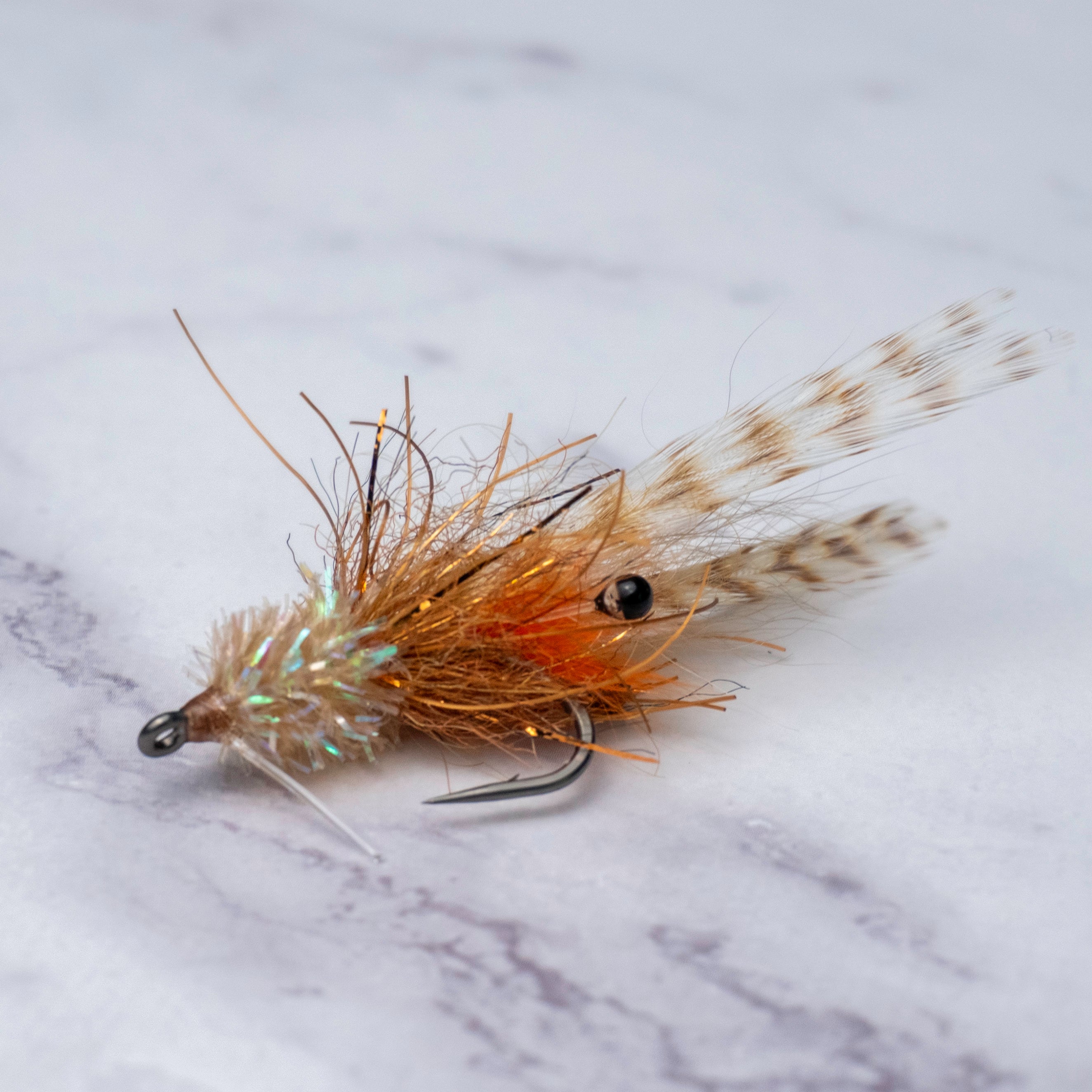 Tan and orange Bull Shrimp saltwater fly from the limited Summer Collection with barred legs, weedguard, and Size 2 Mustad Tarpon Streamer hook for shallow water redfish and snook.