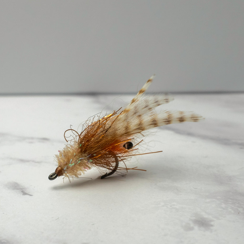 Close-up of the Bull Shrimp fly in natural tan coloration tied weightless for redfish and snook feeding in grass flats, mangroves, and skinny water.