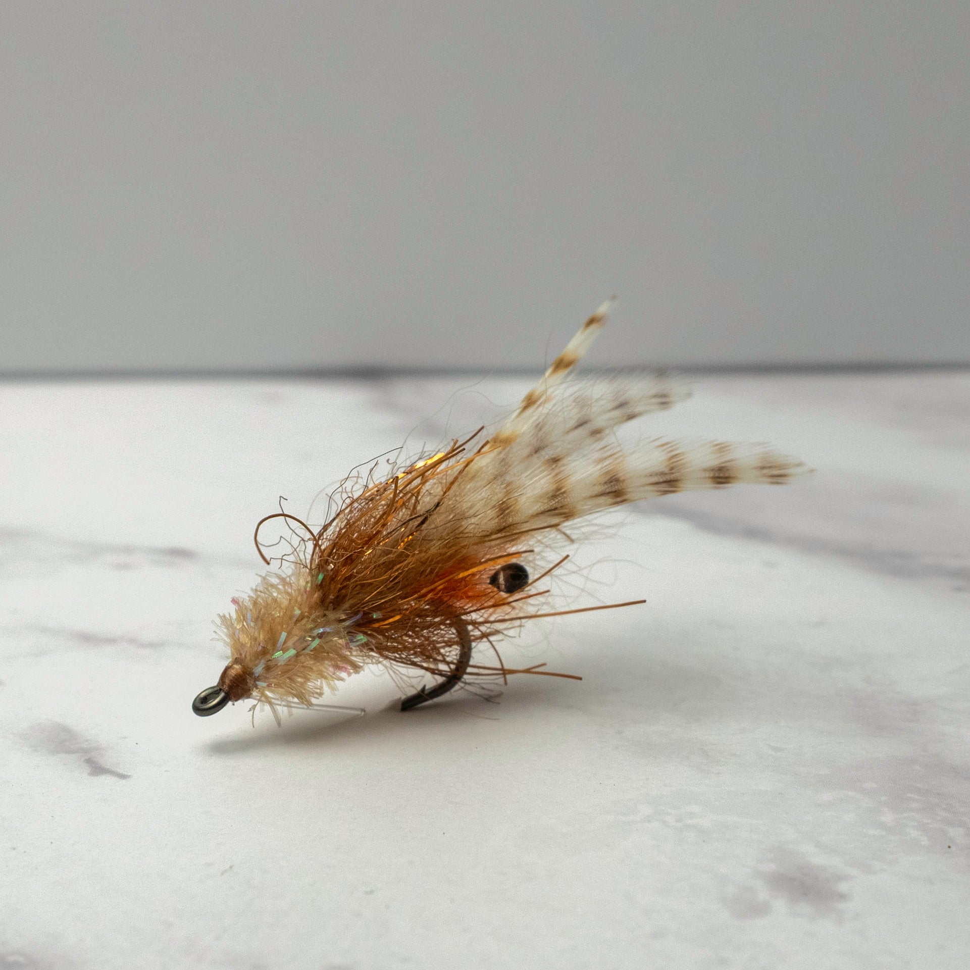 Close-up of the Bull Shrimp fly in natural tan coloration tied weightless for redfish and snook feeding in grass flats, mangroves, and skinny water.