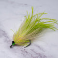 Chartreuse and tan Tickler tarpon fly with beach chain eyes, flowing feather profile, and a size 1/0 Mustad Rune Big Game Hook designed for backwater tarpon and summer migration fish.