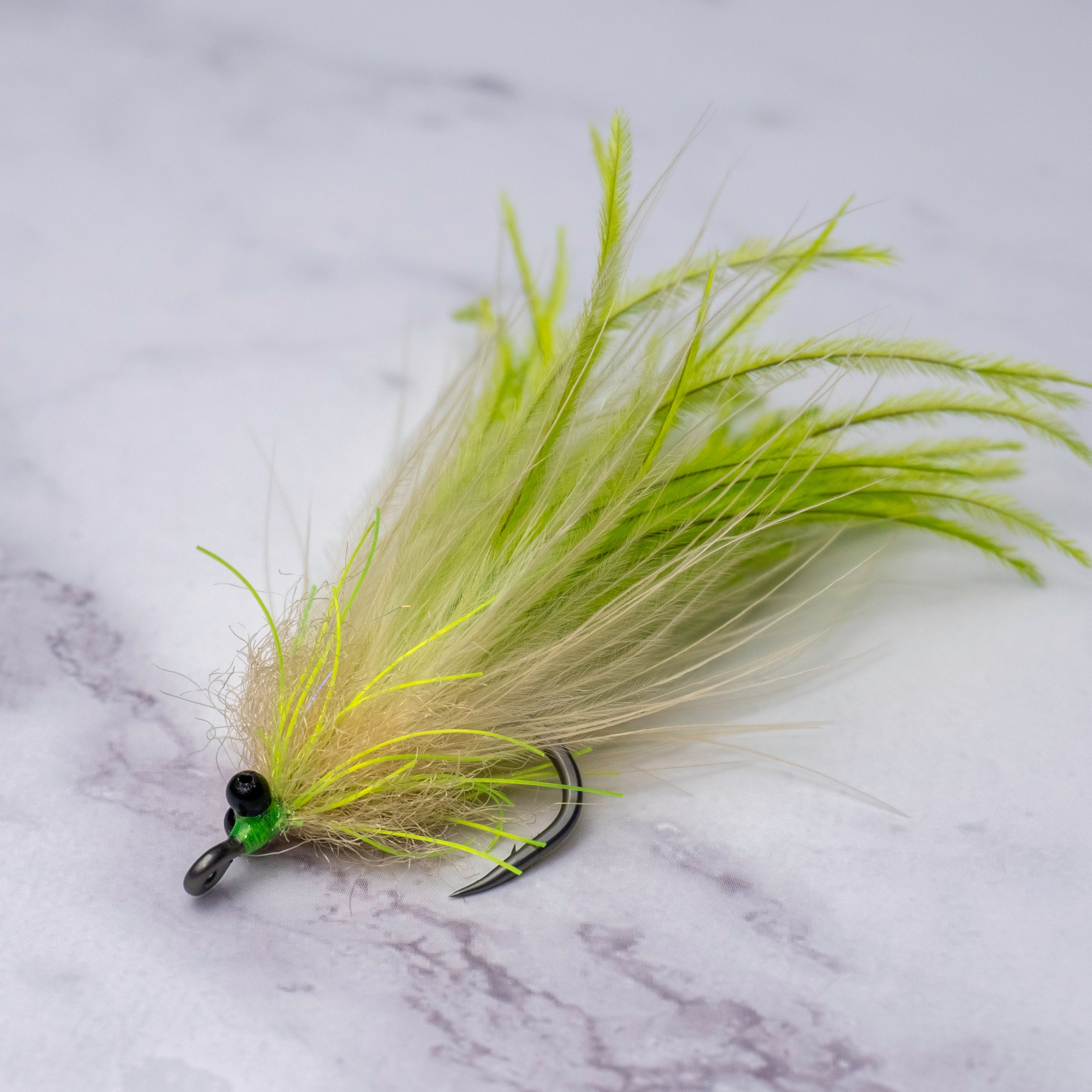 Chartreuse and tan Tickler tarpon fly with beach chain eyes, flowing feather profile, and a size 1/0 Mustad Rune Big Game Hook designed for backwater tarpon and summer migration fish.