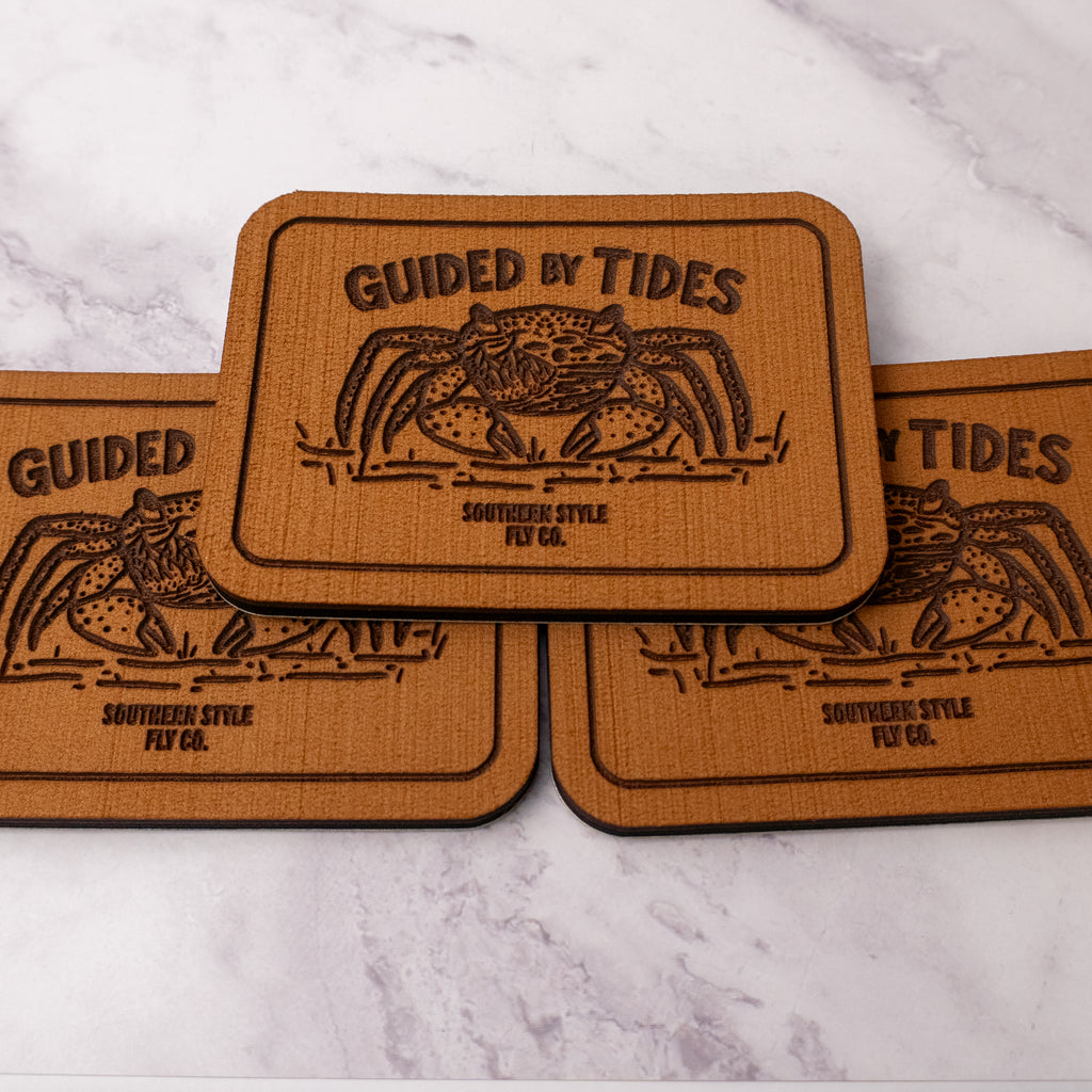 Tan 2.8 x 4 inch Southern Style Fly Co. peel-and-stick foam fly pad with the Guided by Tides mangrove crab logo and adhesive backing for organizing flies on the water.