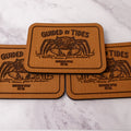 Tan 2.8 x 4 inch Southern Style Fly Co. peel-and-stick foam fly pad with the Guided by Tides mangrove crab logo and adhesive backing for organizing flies on the water.
