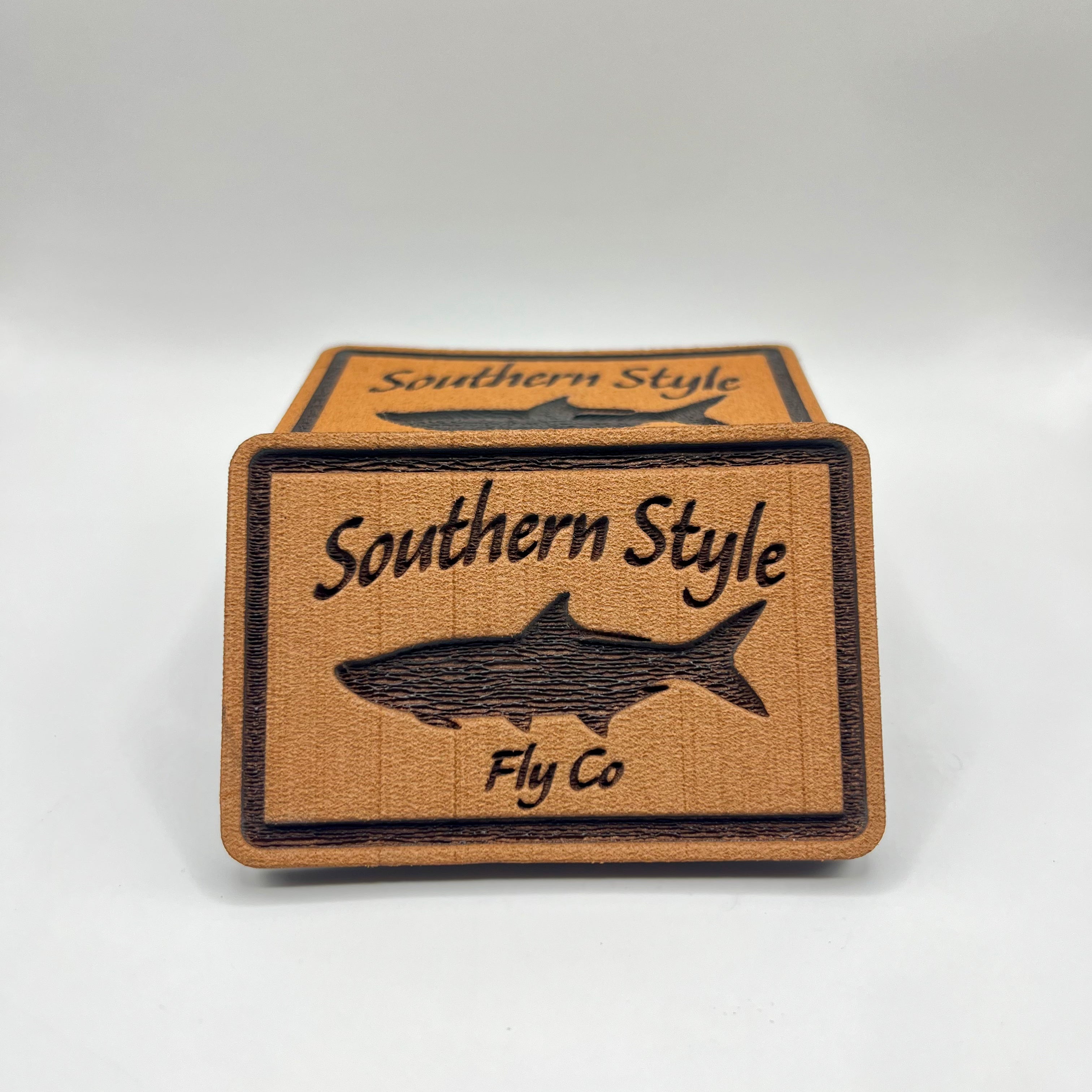 Grey 2x3 peel-and-stick foam fly pad with Southern Style Fly Co. tarpon logo, designed for mounting on fly boxes, coolers, or boat consoles.