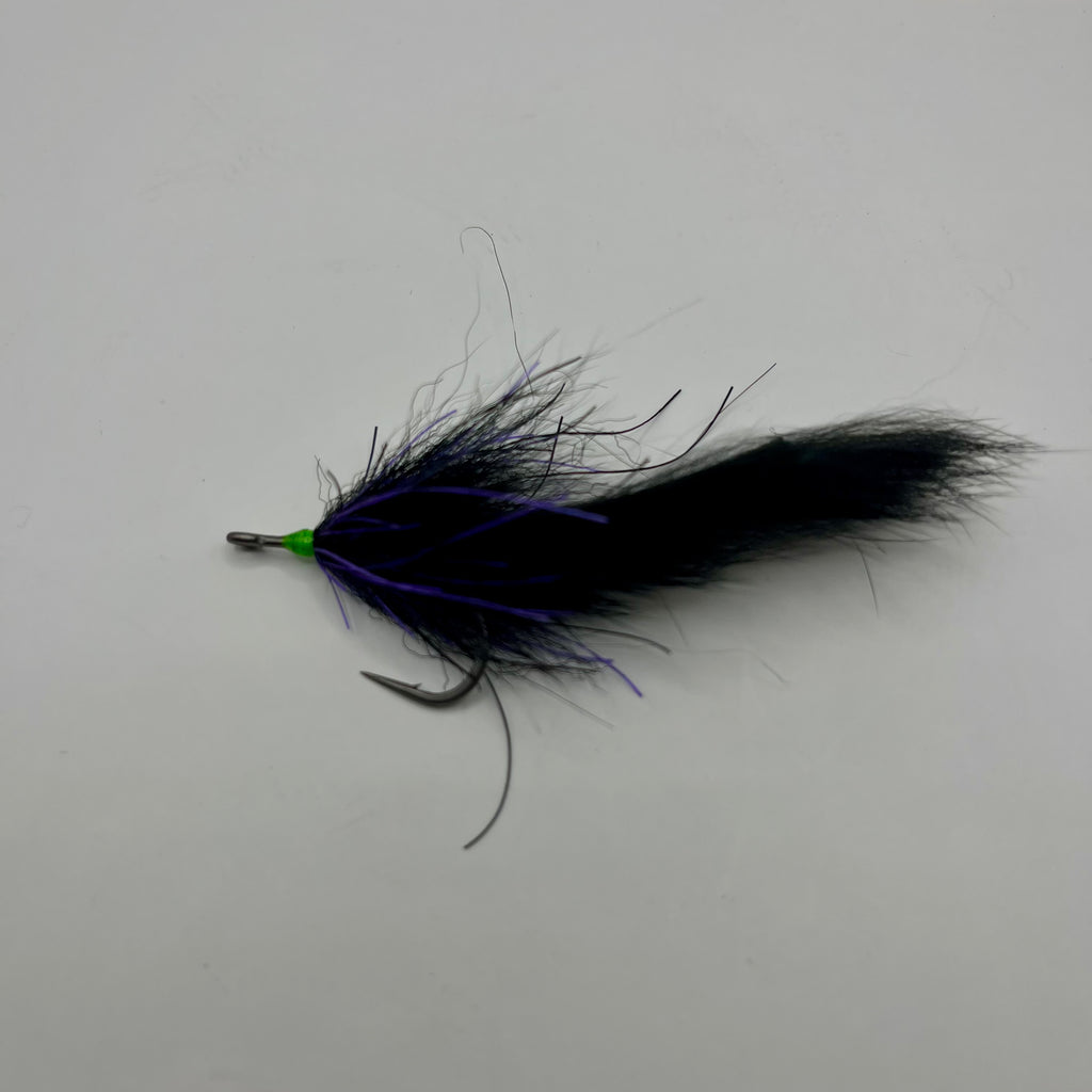 Full profile view of Tarpon Cigar fly in purple and black, slim pattern designed for laid-up and cruising tarpon