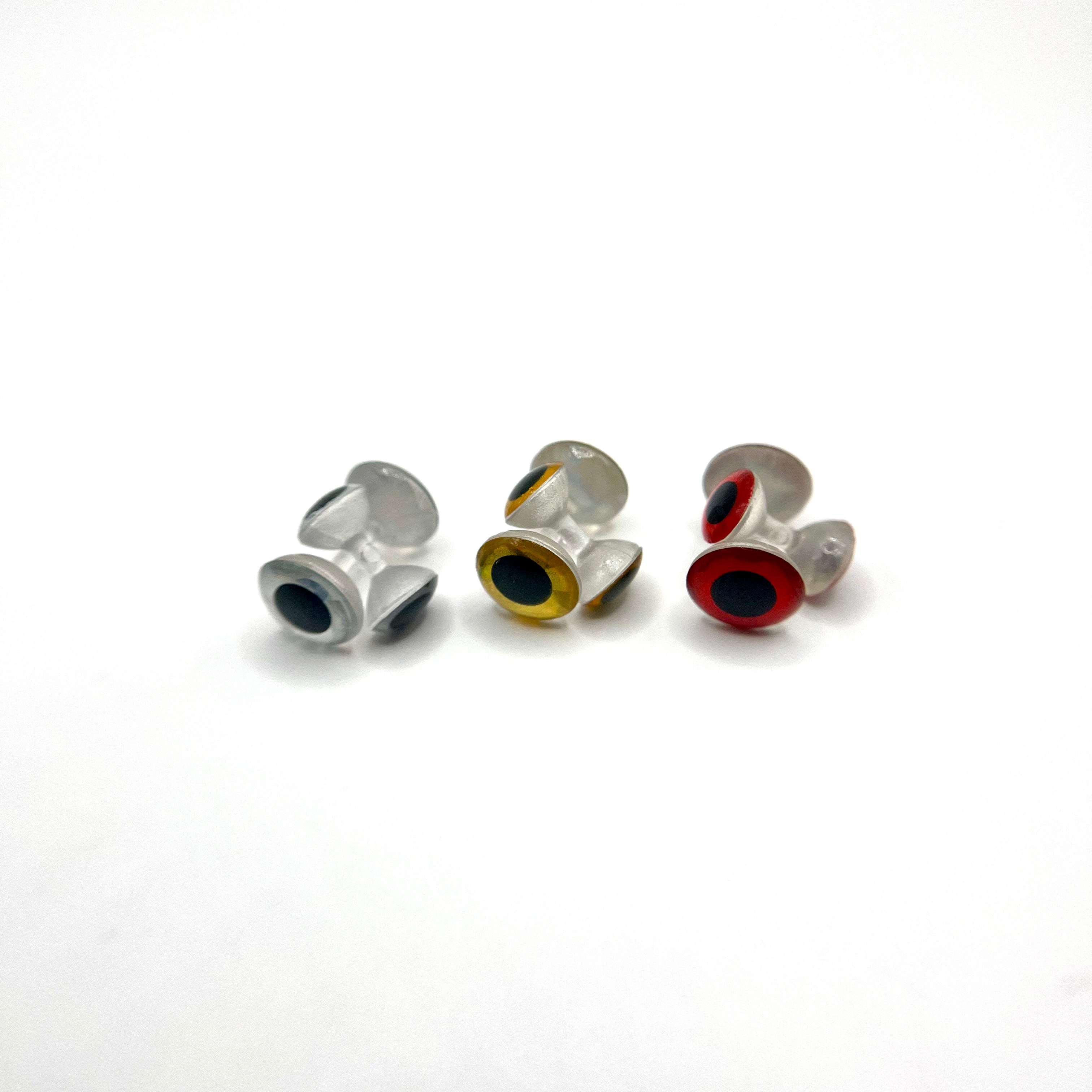 Side profile view of weightless 3D dumbbell eyes in silver, gold, and red, highlighting low-profile shape and horizontal integration for fly tying applications.