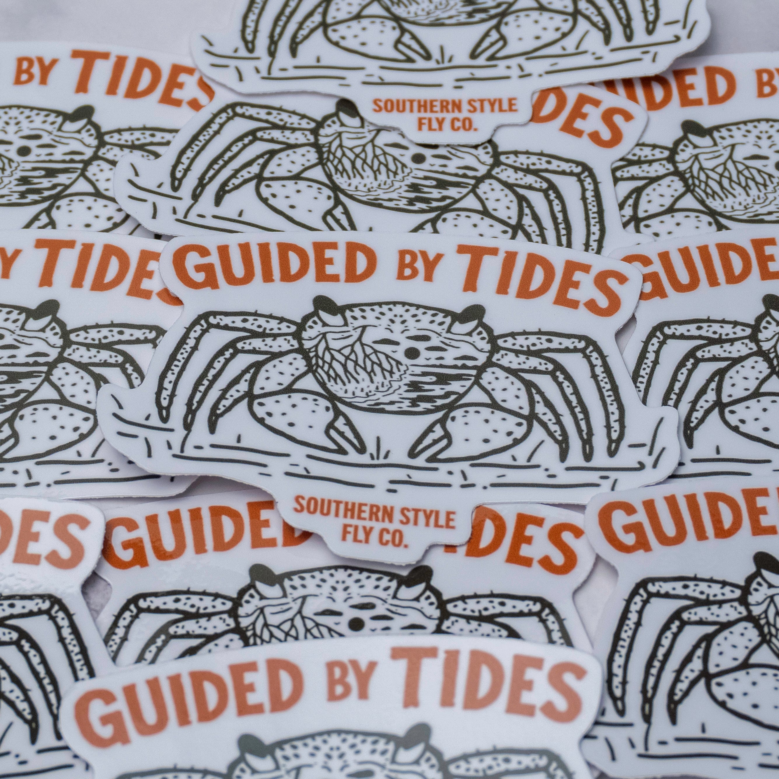 Mangrove crab illustration sticker with “Guided By Tides” text in orange and Southern Style Fly Co branding on a white background.