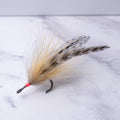 Natural-colored Southern Roach tarpon fly featuring tan bucktail, flowing hair, and barred saddle hackles on a saltwater fly hook.