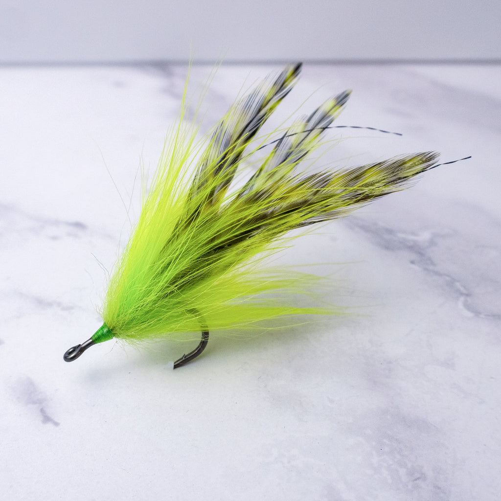 Chartreuse Southern Roach tarpon fly with bright synthetic hair and barred saddle hackles tied on a premium saltwater streamer hook.